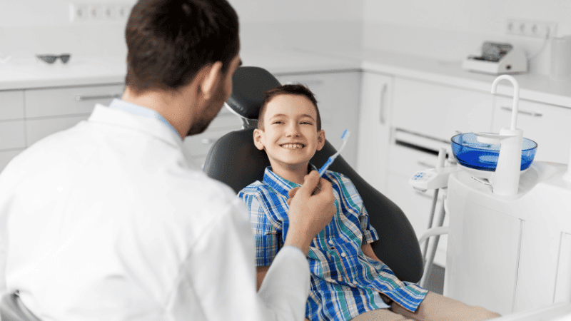 doctor examining kids oral hygine